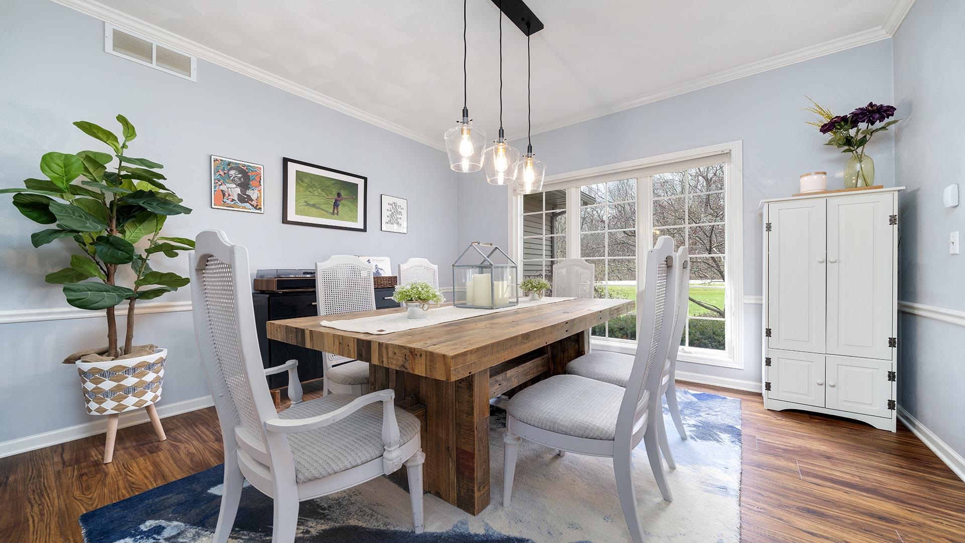 7676 Forest Way Roscoe, IL 61073 - Photo 8 of 56 a view of a dining room with furniture window and wooden floor
