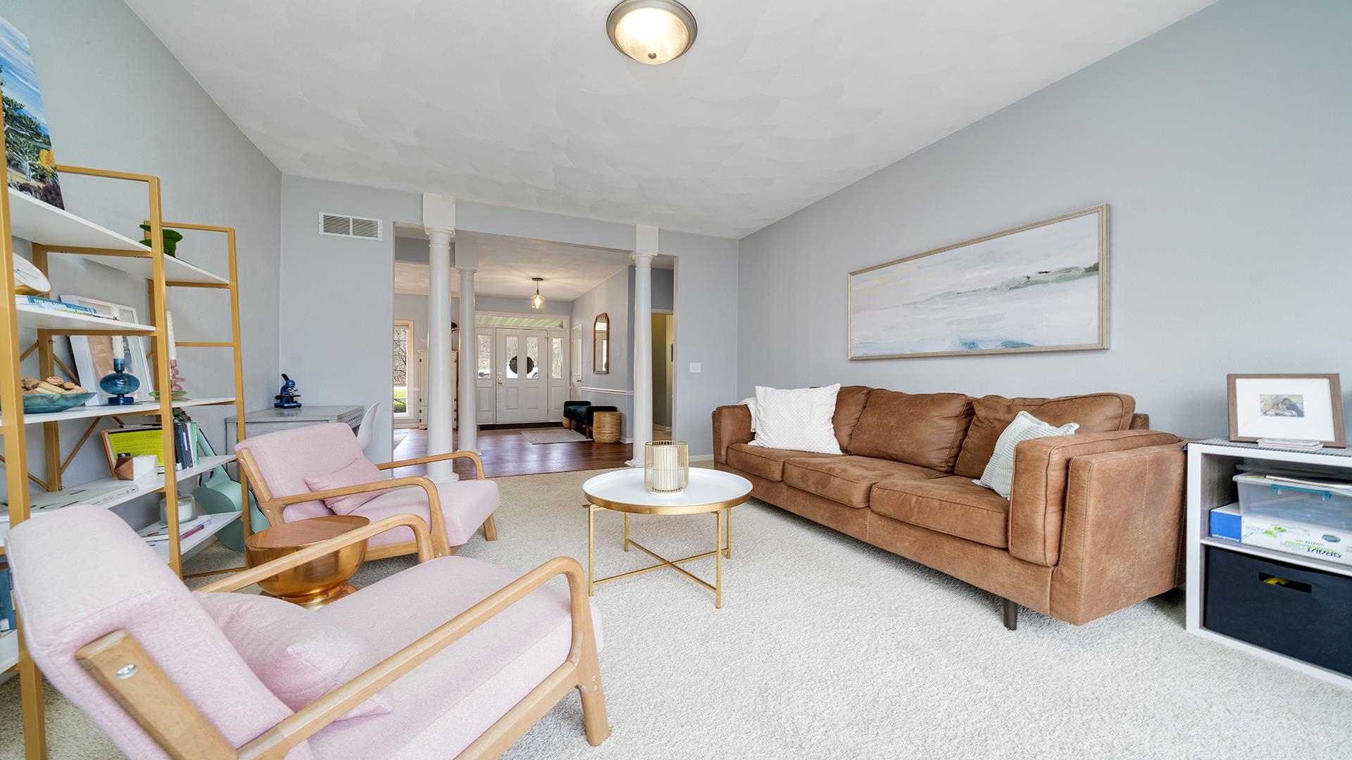 7676 Forest Way Roscoe, IL 61073 - Photo 9 of 56 a living room with furniture a rug and a bookshelf