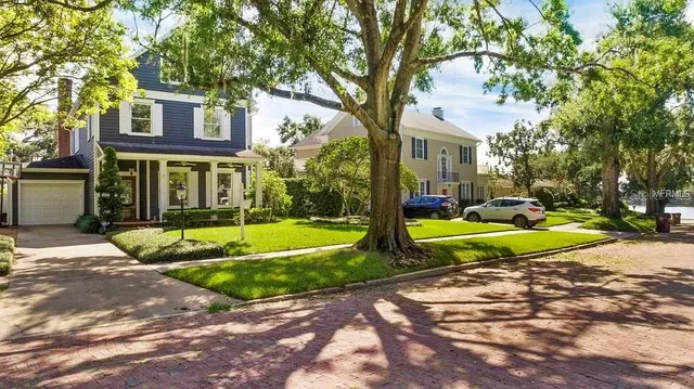 a view of a house with a yard patio and a small yard