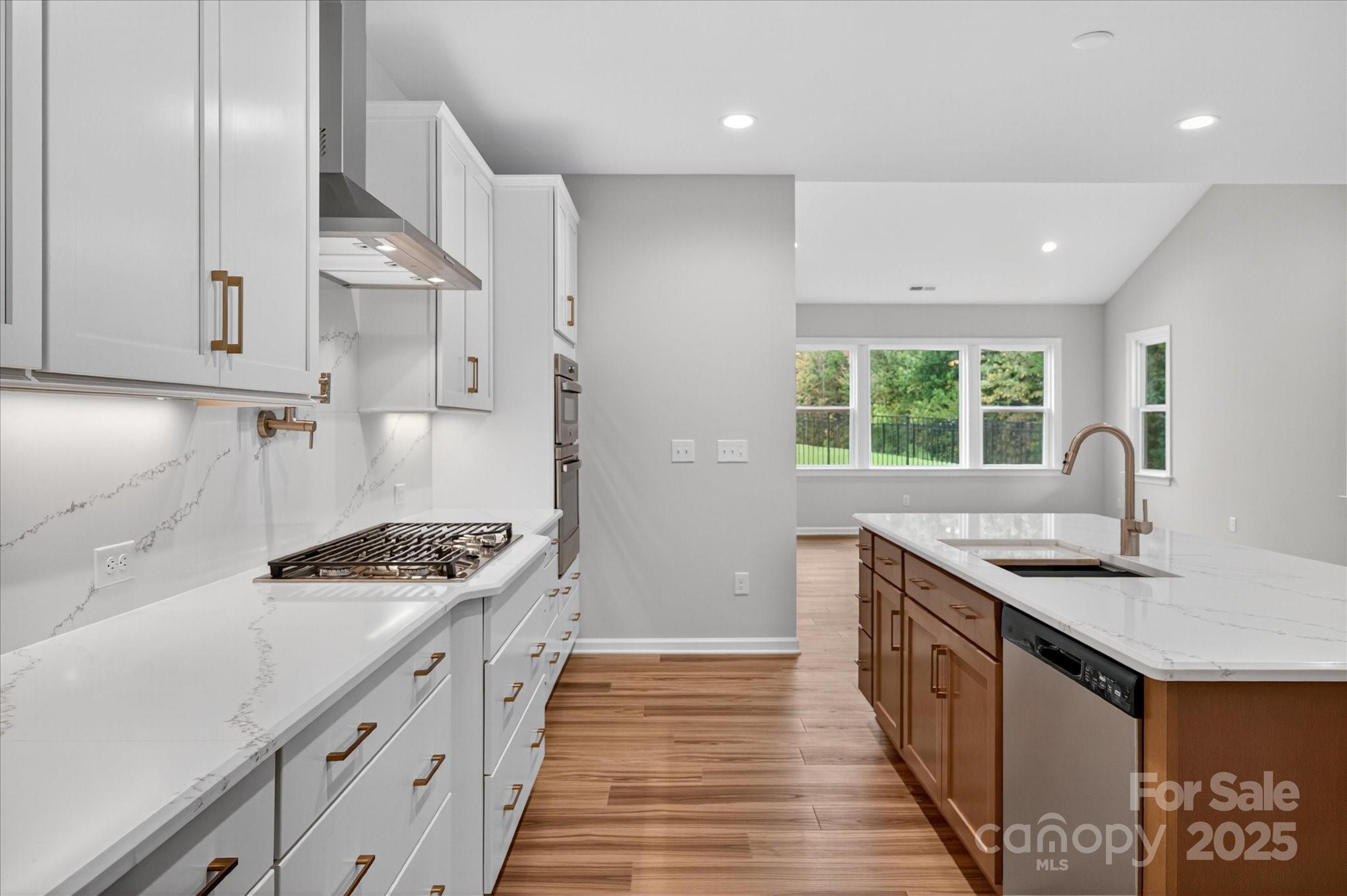 7926 Rolling Wheels Road, Unit KEN0008 Charlotte, NC 28215 - Photo 12 of 47 a kitchen with stainless steel appliances granite countertop a stove a sink and a refrigerator