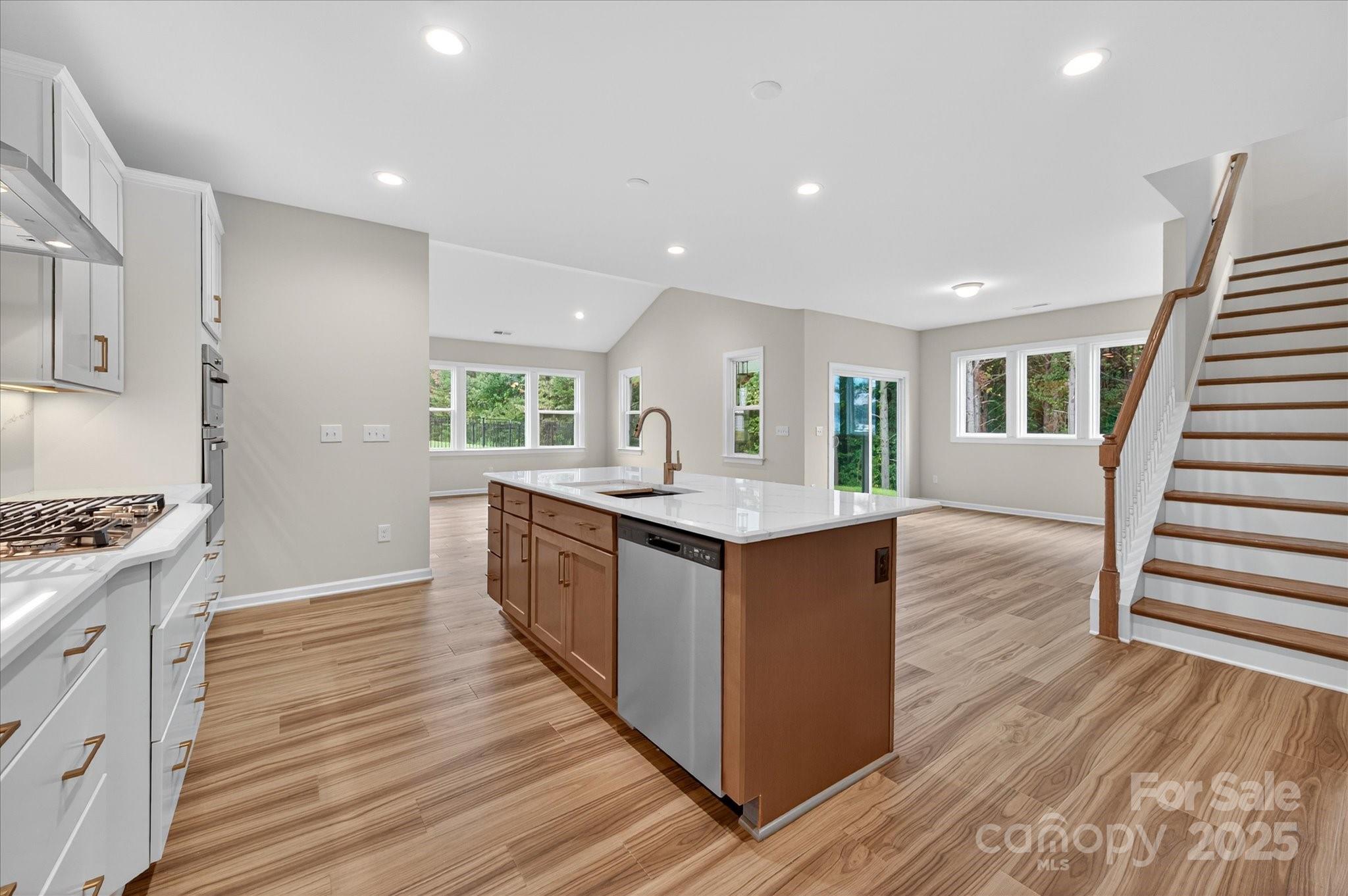 7926 Rolling Wheels Road, Unit KEN0008 Charlotte, NC 28215 - Photo 13 of 47 a large kitchen with wooden floor and a sink