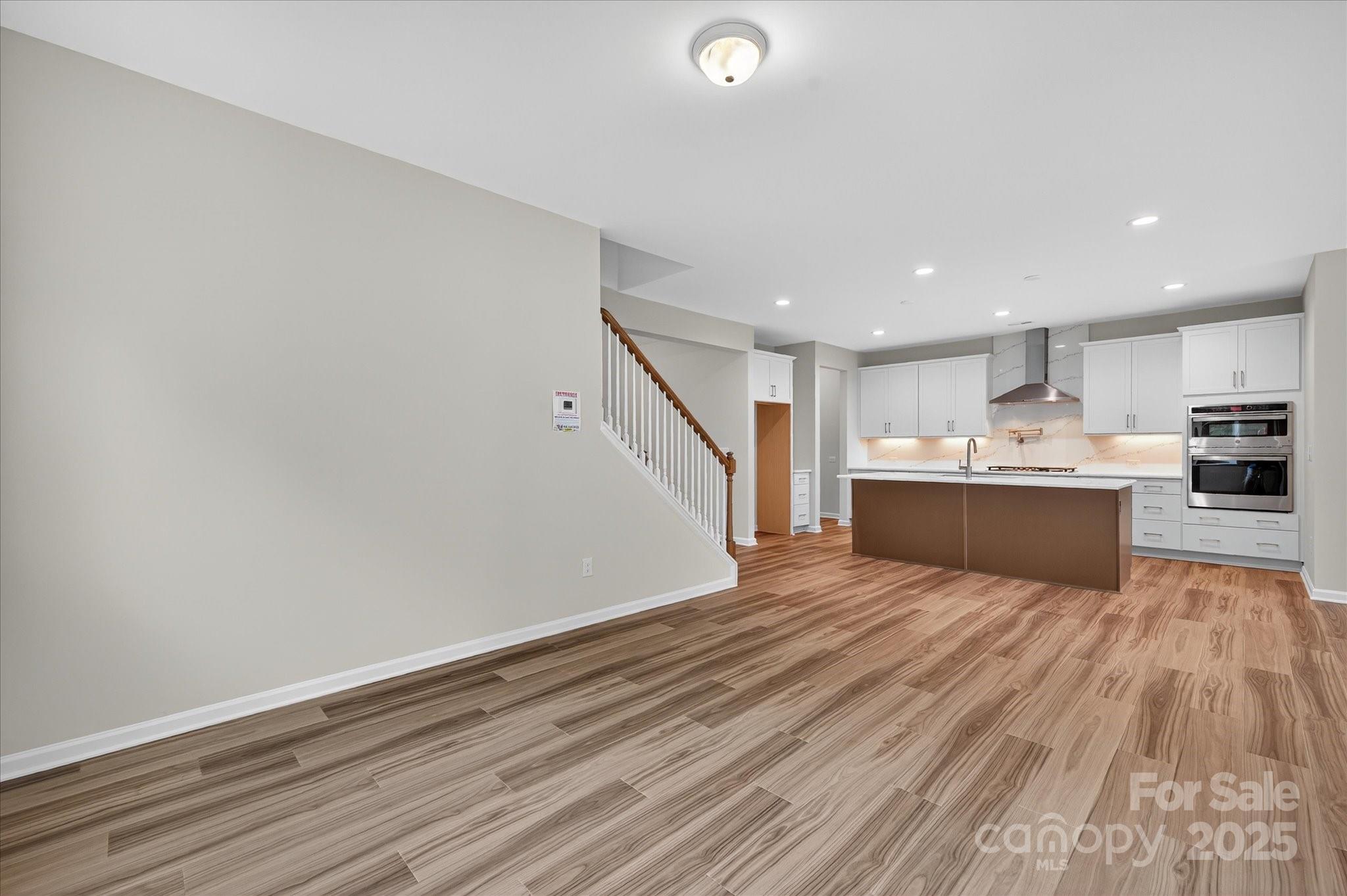 7926 Rolling Wheels Road, Unit KEN0008 Charlotte, NC 28215 - Photo 17 of 47 a view of kitchen with wooden floor