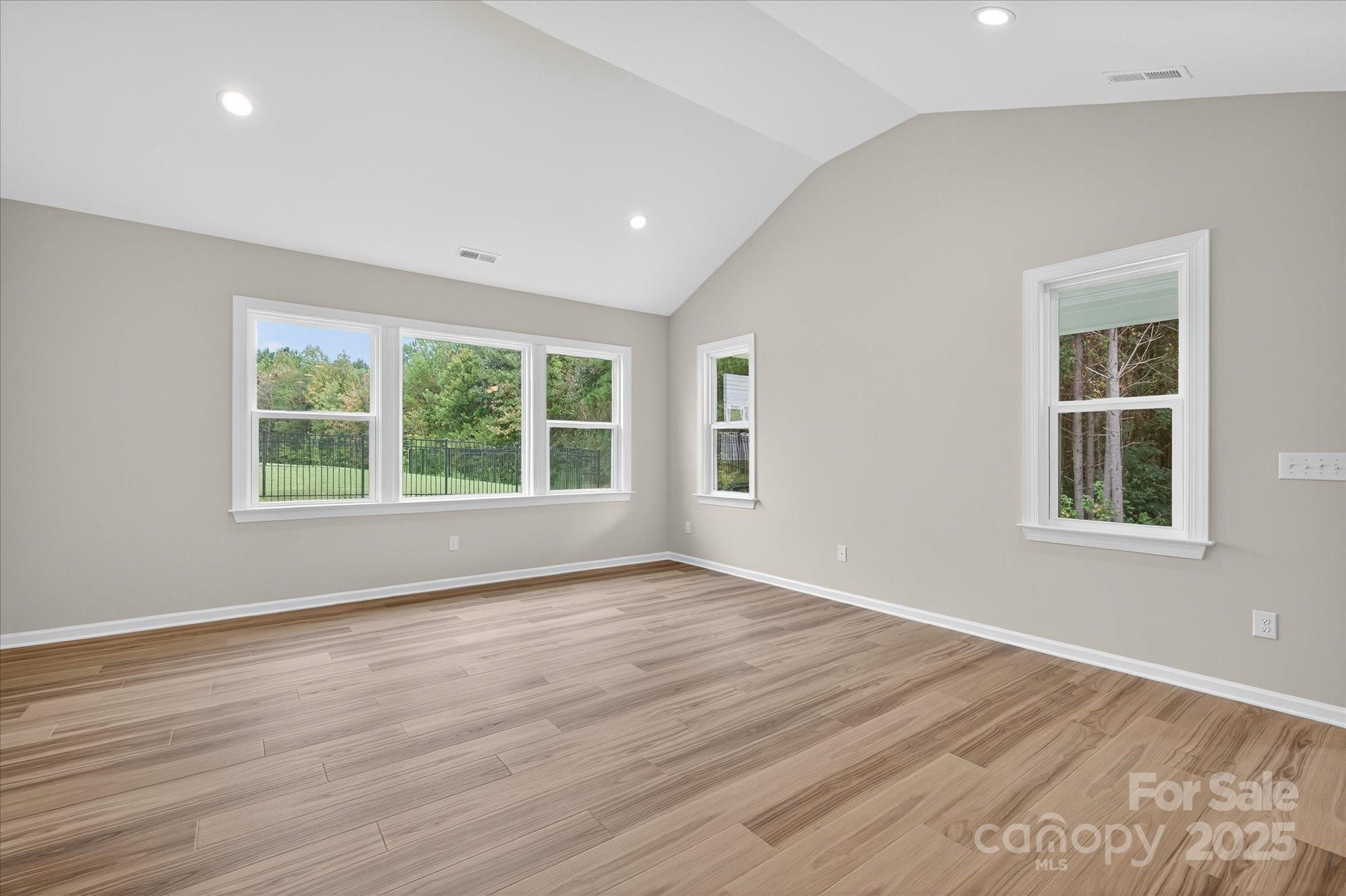 7926 Rolling Wheels Road, Unit KEN0008 Charlotte, NC 28215 - Photo 19 of 47 a view of an empty room with wooden floor and a window