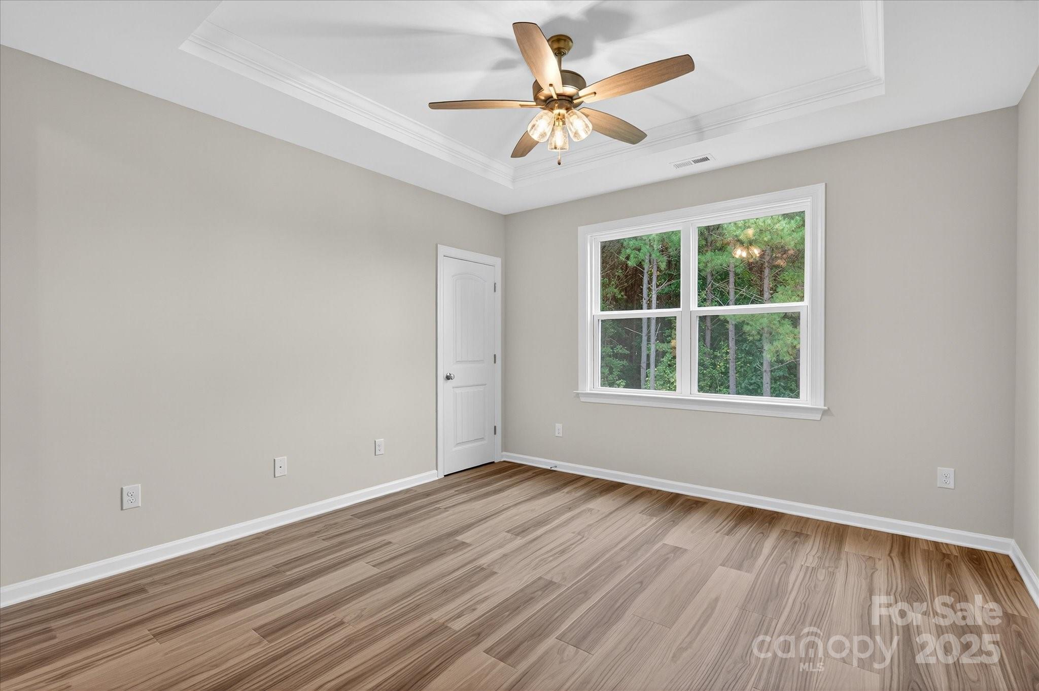 7926 Rolling Wheels Road, Unit KEN0008 Charlotte, NC 28215 - Photo 22 of 47 an empty room with wooden floor and windows