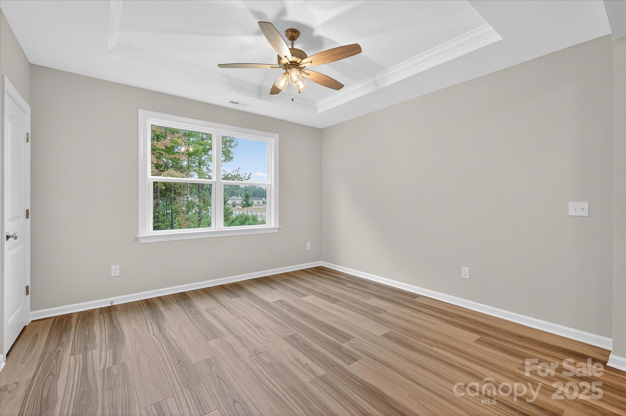 7926 Rolling Wheels Road, Unit KEN0008 Charlotte, NC 28215 - Photo 23 of 47 wooden floor in an empty room with a window