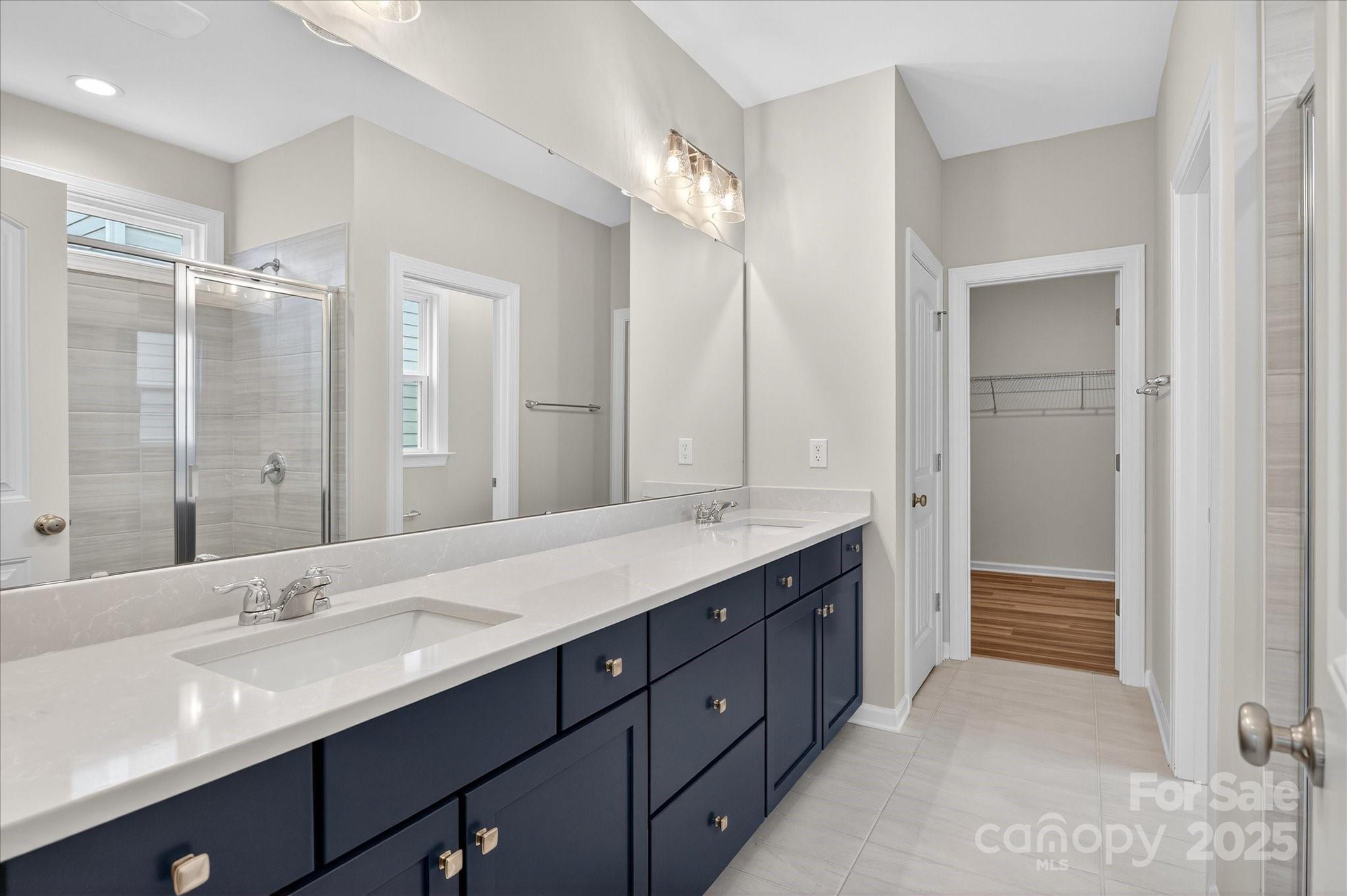 7926 Rolling Wheels Road, Unit KEN0008 Charlotte, NC 28215 - Photo 26 of 47 a bathroom with a double vanity sink mirror and double