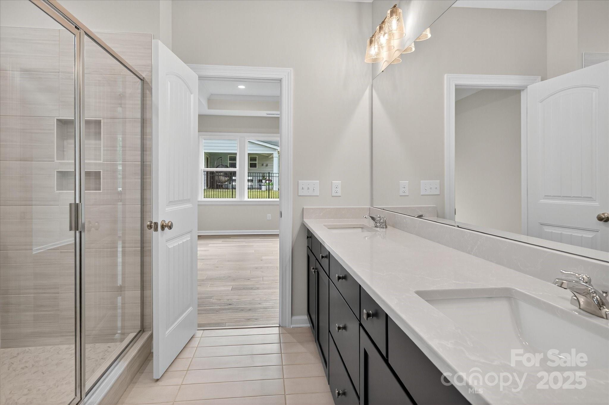 7926 Rolling Wheels Road, Unit KEN0008 Charlotte, NC 28215 - Photo 28 of 47 a bathroom with a tub sink and mirror