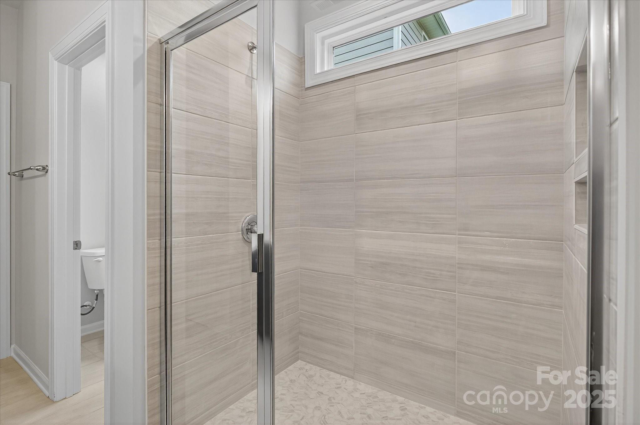 7926 Rolling Wheels Road, Unit KEN0008 Charlotte, NC 28215 - Photo 29 of 47 a bathroom with a shower