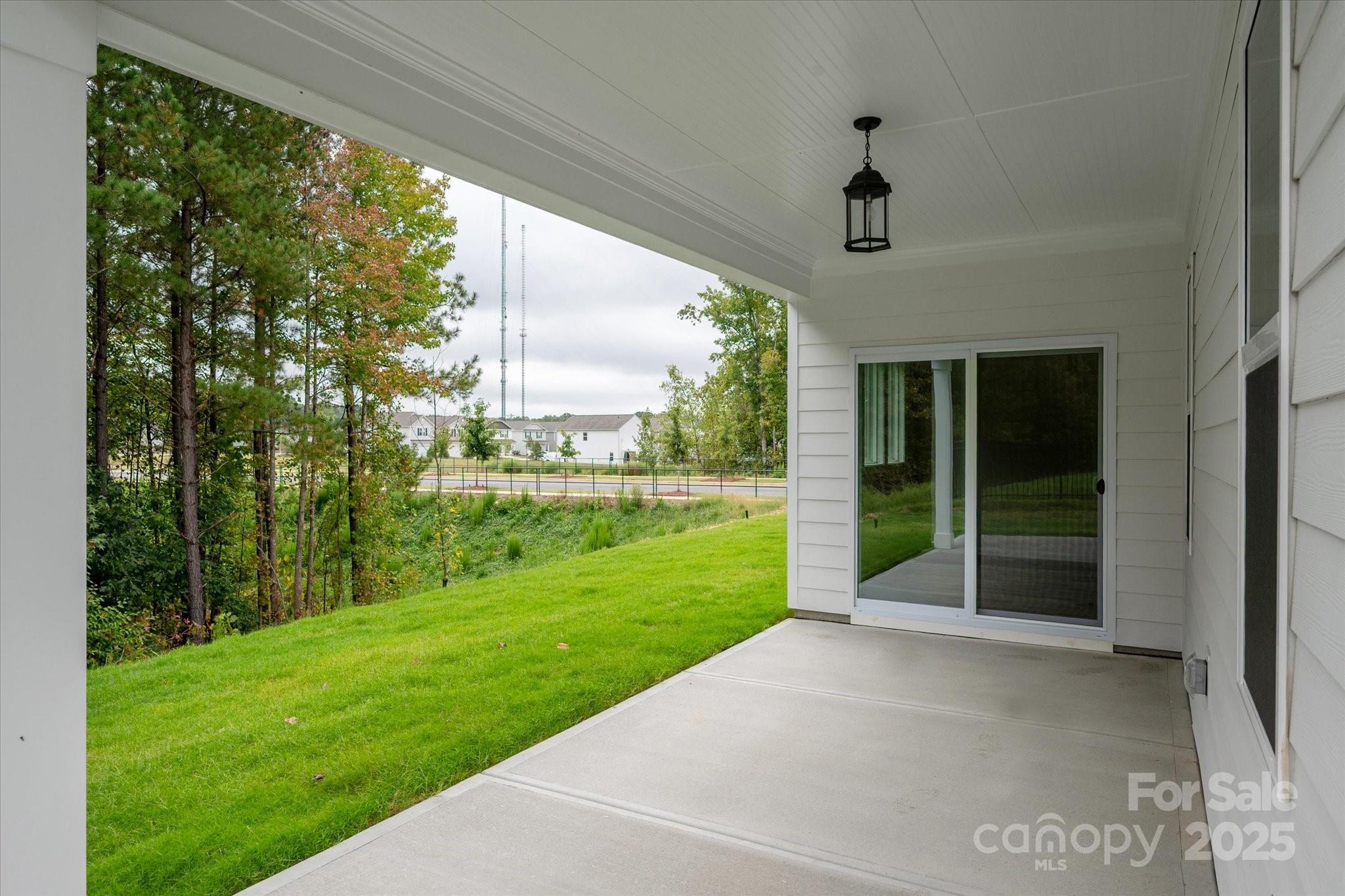 7926 Rolling Wheels Road, Unit KEN0008 Charlotte, NC 28215 - Photo 3 of 47 a view of a porch and garden