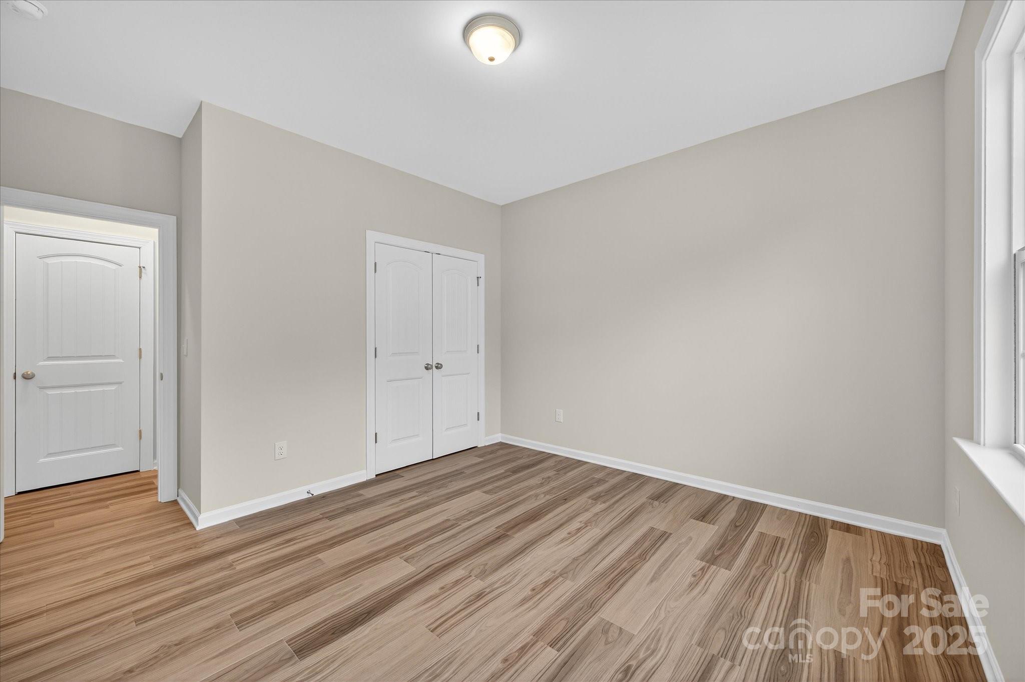 7926 Rolling Wheels Road, Unit KEN0008 Charlotte, NC 28215 - Photo 33 of 47 a view of room with wooden floor