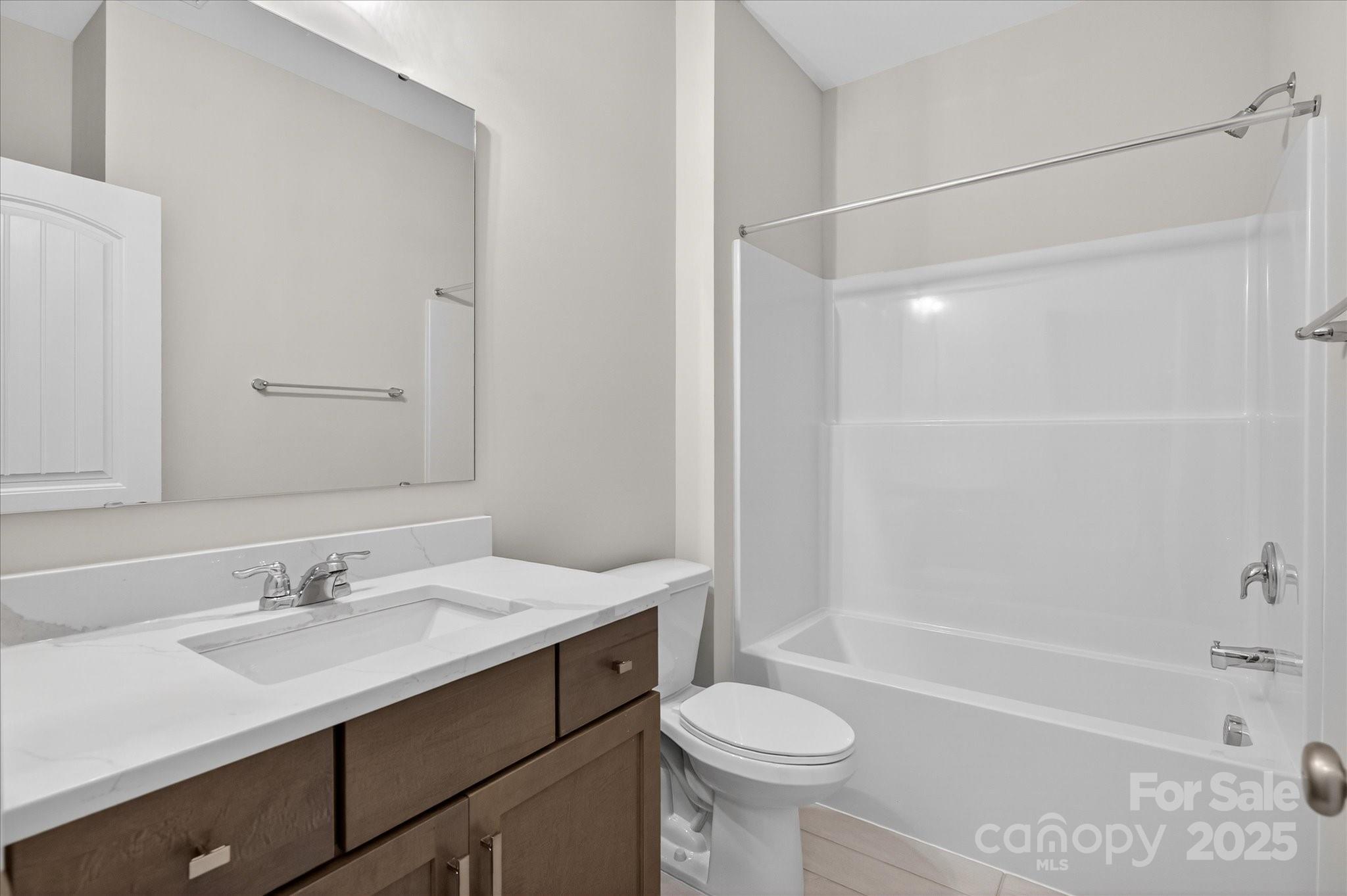 7926 Rolling Wheels Road, Unit KEN0008 Charlotte, NC 28215 - Photo 34 of 47 a bathroom with a sink a toilet and shower