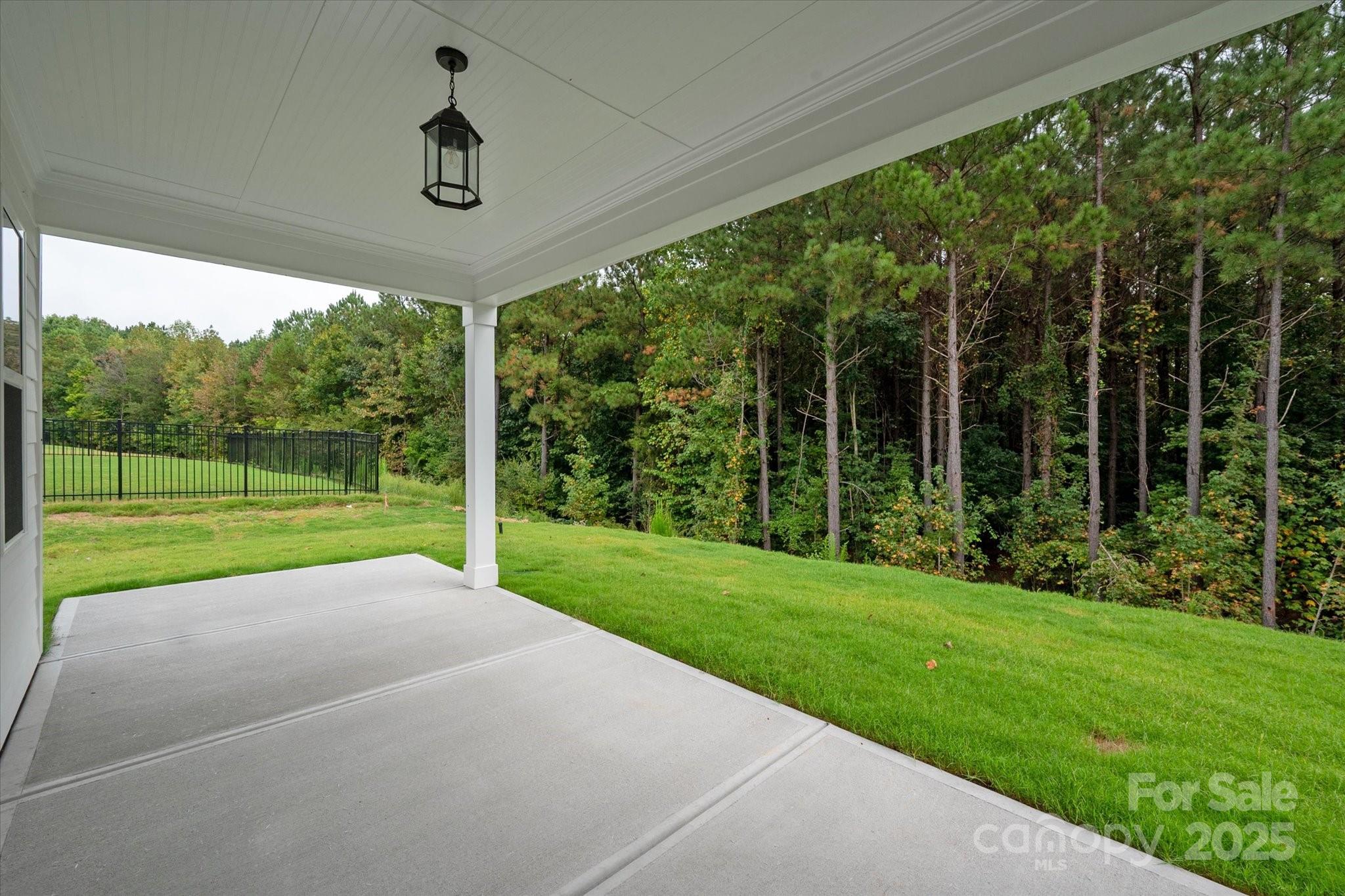 7926 Rolling Wheels Road, Unit KEN0008 Charlotte, NC 28215 - Photo 45 of 47 a view of a porch with a big yard