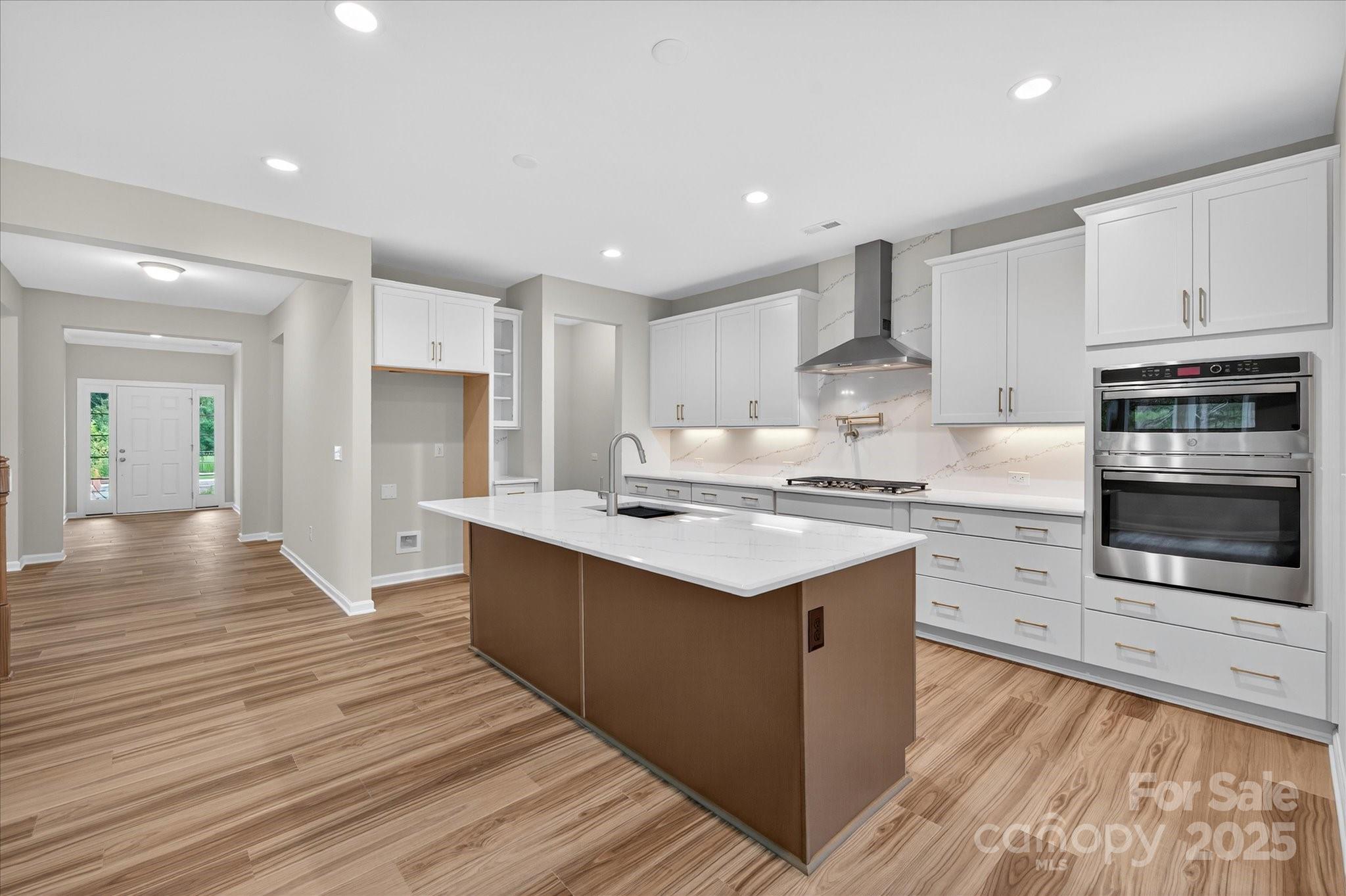7926 Rolling Wheels Road, Unit KEN0008 Charlotte, NC 28215 - Photo 6 of 47 a kitchen with stainless steel appliances kitchen island granite countertop a sink and cabinets