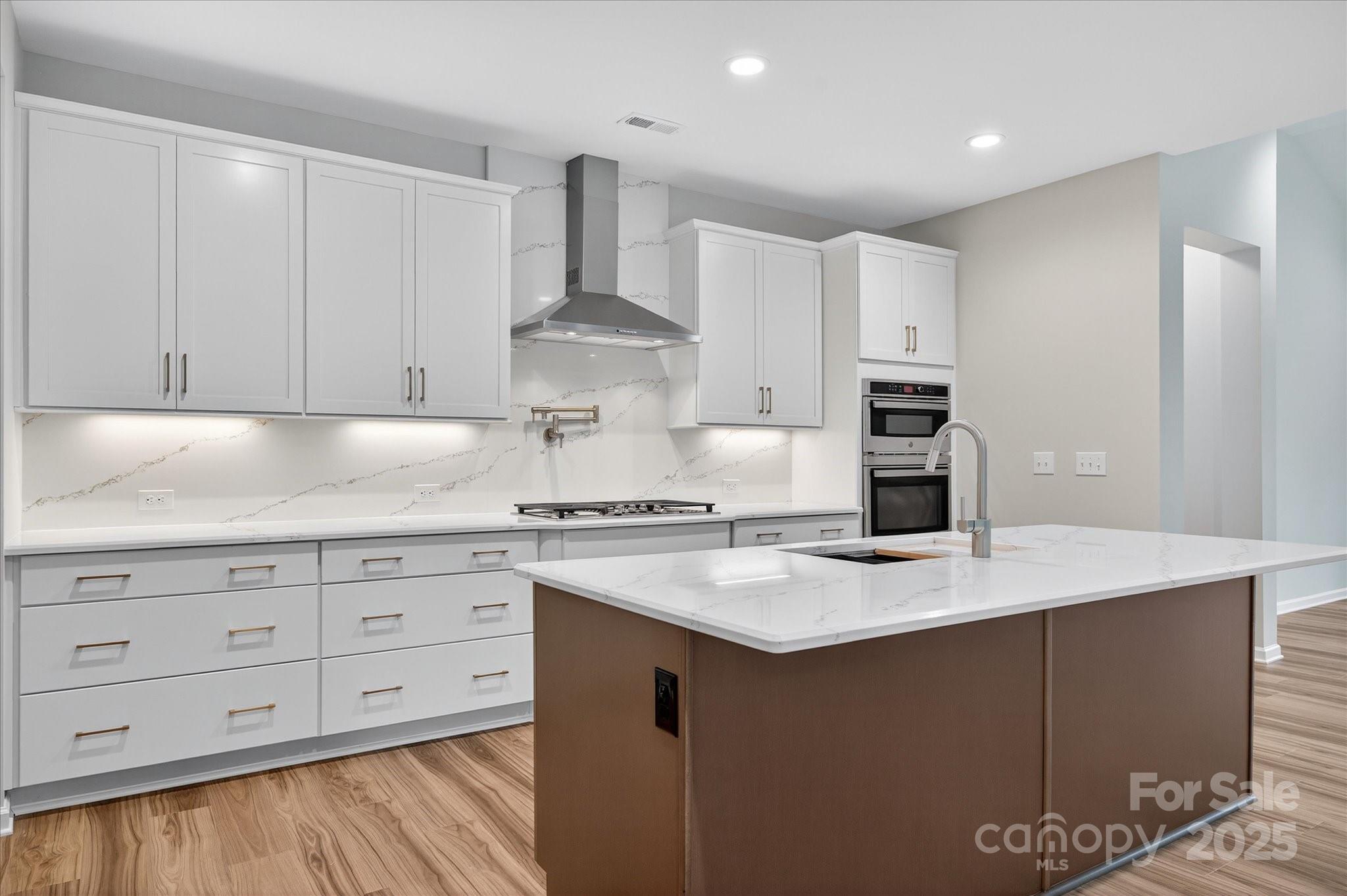 7926 Rolling Wheels Road, Unit KEN0008 Charlotte, NC 28215 - Photo 8 of 47 a kitchen with granite countertop white cabinets white stove a sink and dishwasher