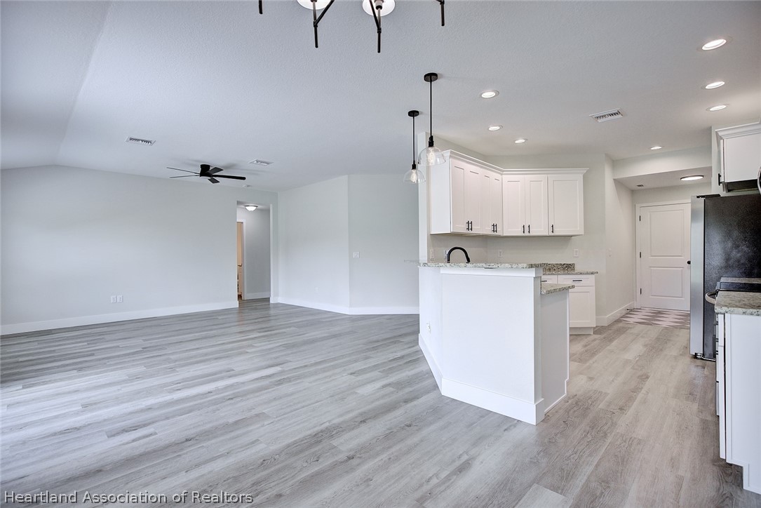 111 Vale Court Sebring, FL 33876 - Photo 9 of 40 a view of kitchen with cabinets appliances and wooden floor