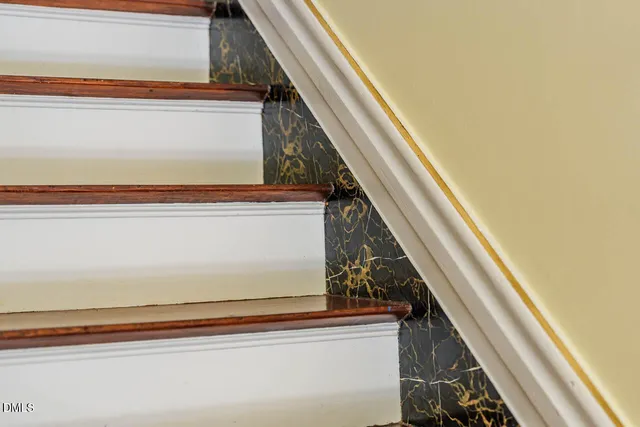 a living room with fireplace furniture and a chandelier
