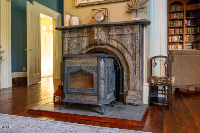 a living room with furniture fireplace and a large window