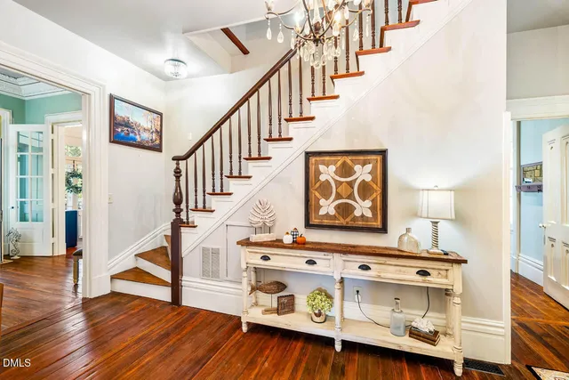 a bedroom with a bed and a chandelier