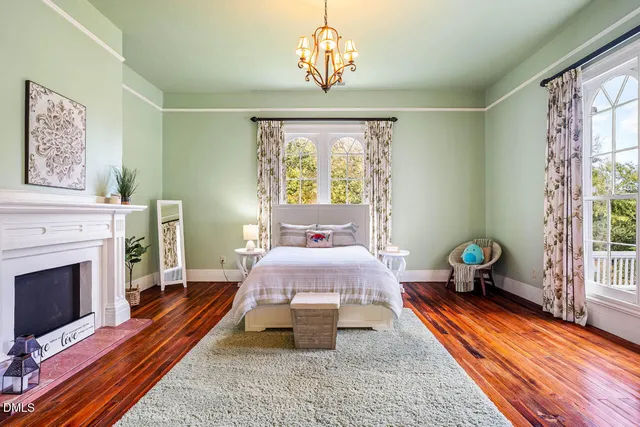 a view of a patio with plants and chairs under an umbrella
