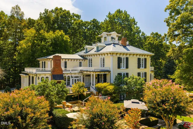a white house with a yard and sitting area