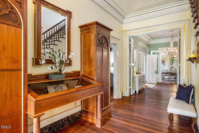 a view of a hallway with wooden floor and staircase