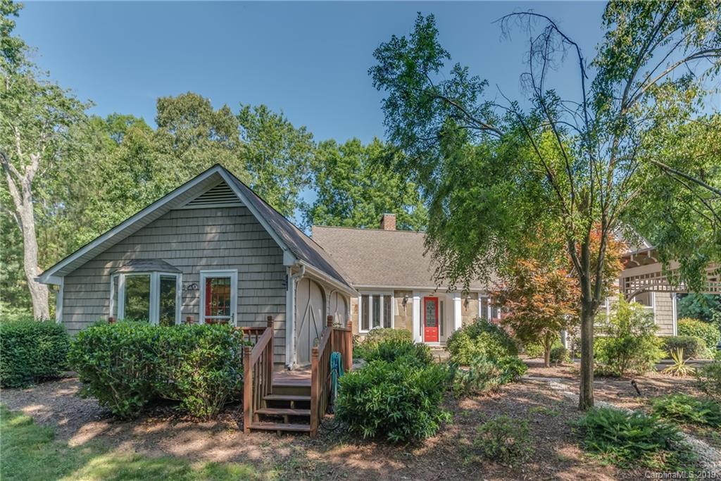 1790 Red Fox Road Tryon, NC 28782 - Photo 2 of 40 a view of a house with brick walls and a yard with plants and large trees