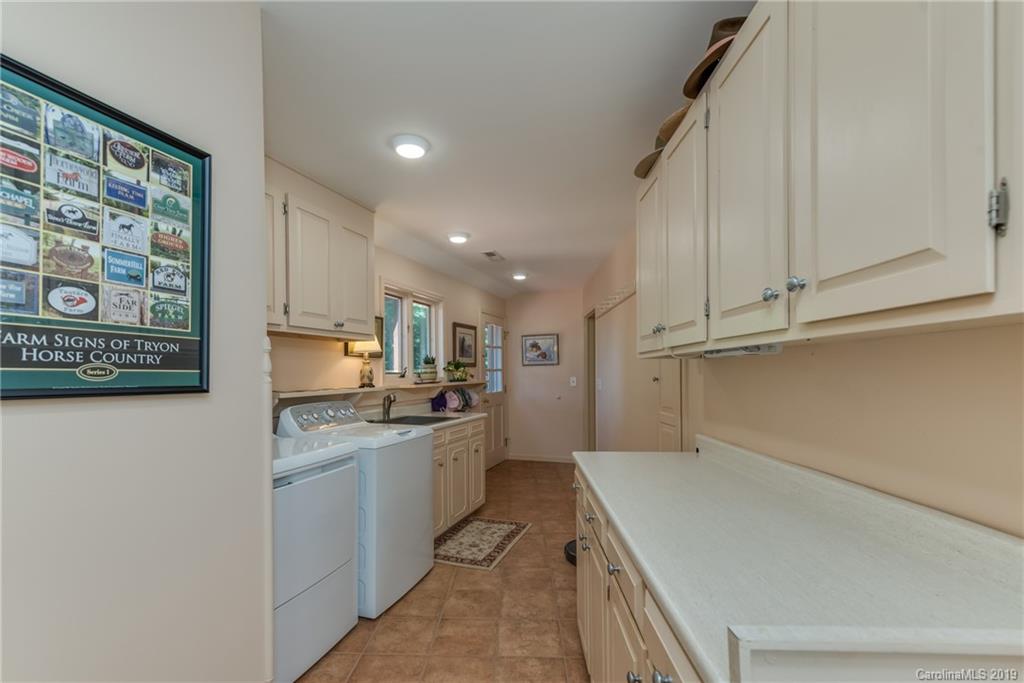 1790 Red Fox Road Tryon, NC 28782 - Photo 13 of 40 a kitchen with a sink a stove and cabinets