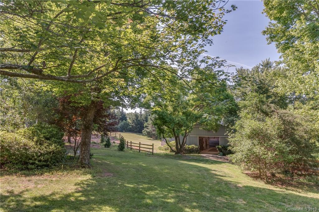 1790 Red Fox Road Tryon, NC 28782 - Photo 15 of 40 a front view of a house with a garden and trees