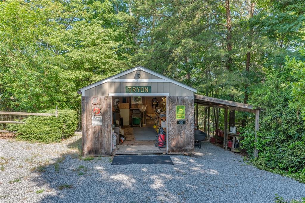 1790 Red Fox Road Tryon, NC 28782 - Photo 29 of 40 a view of a wooden house with a small yard and large trees