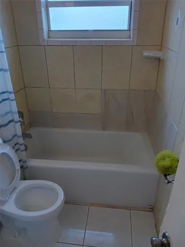 a bathroom with a toilet and a bathtub