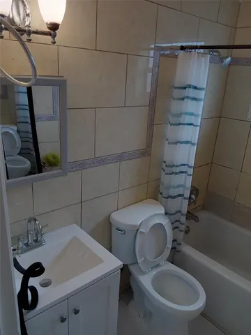 a view of an empty room with a mirror