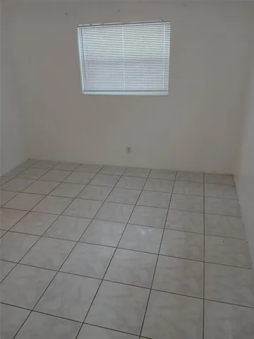 an empty room with a empty space and a window