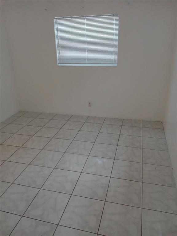 120 Northeast 26th Court Pompano Beach, FL 33064 - Photo 7 of 33 a view of a room that has a window in it