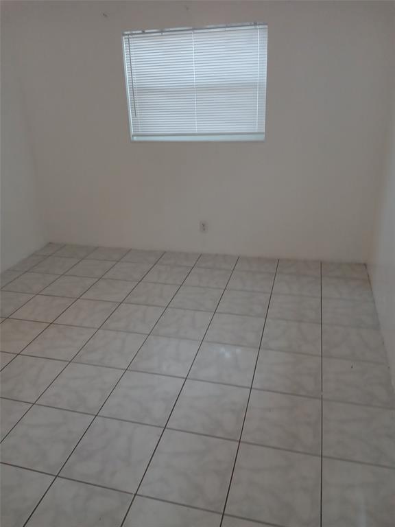120 Northeast 26th Court Pompano Beach, FL 33064 - Photo 8 of 33 an empty room with a empty space and a window