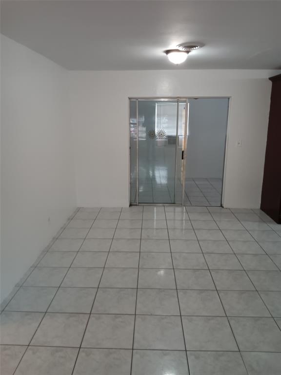 120 Northeast 26th Court Pompano Beach, FL 33064 - Photo 10 of 33 a view of an empty room and window in a room