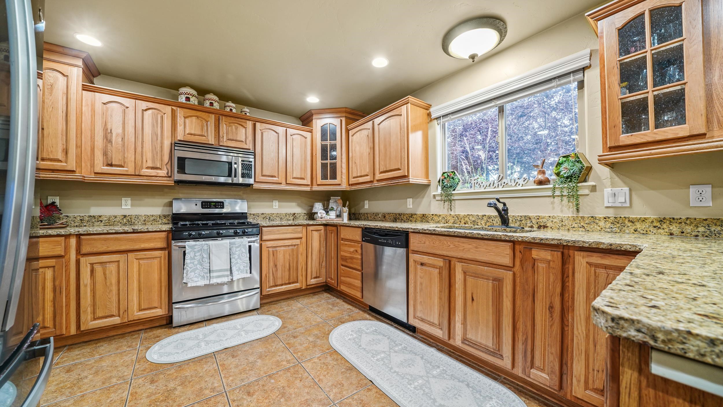 791 Yew Street Fruita, CO 81521 - Photo 12 of 33 a kitchen with stainless steel appliances granite countertop a stove sink and cabinets