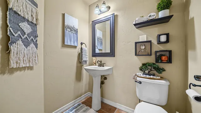 a spacious bedroom with a bed and a chandelier