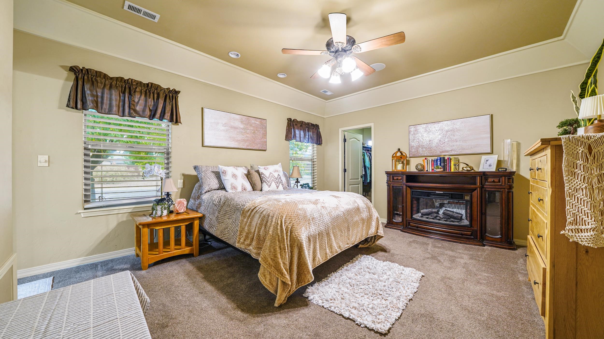 791 Yew Street Fruita, CO 81521 - Photo 17 of 33 a spacious bedroom with a bed and a chandelier