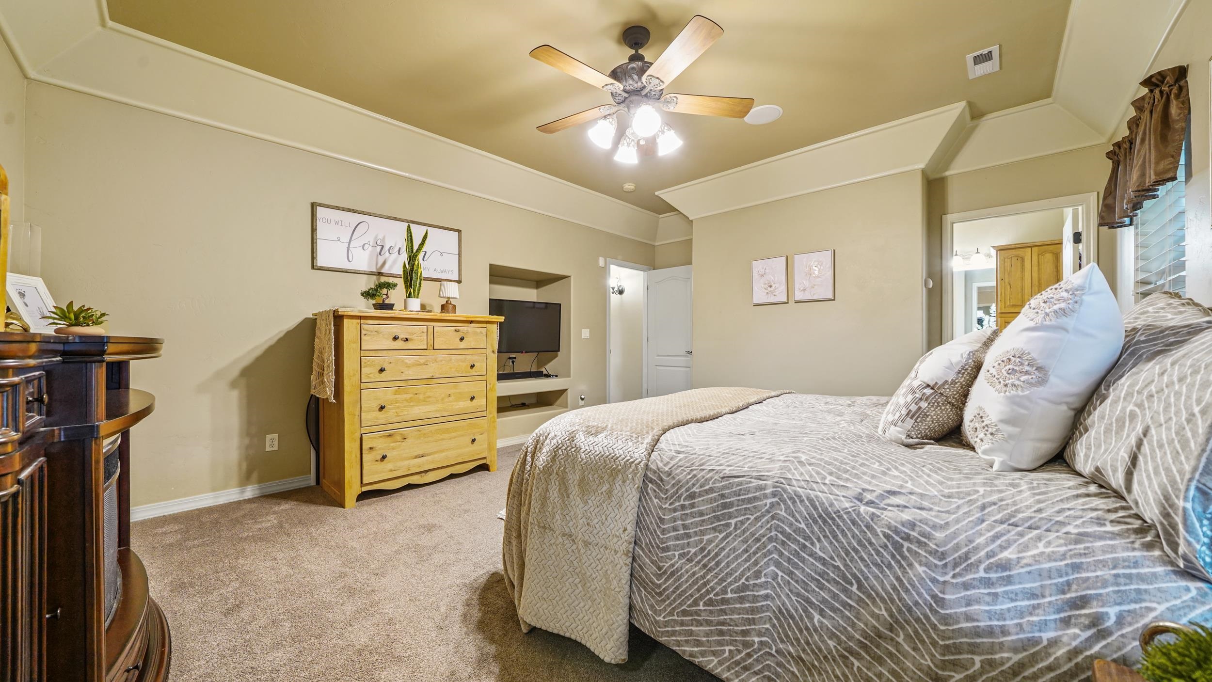 791 Yew Street Fruita, CO 81521 - Photo 18 of 33 a bedroom with a bed and a chandelier