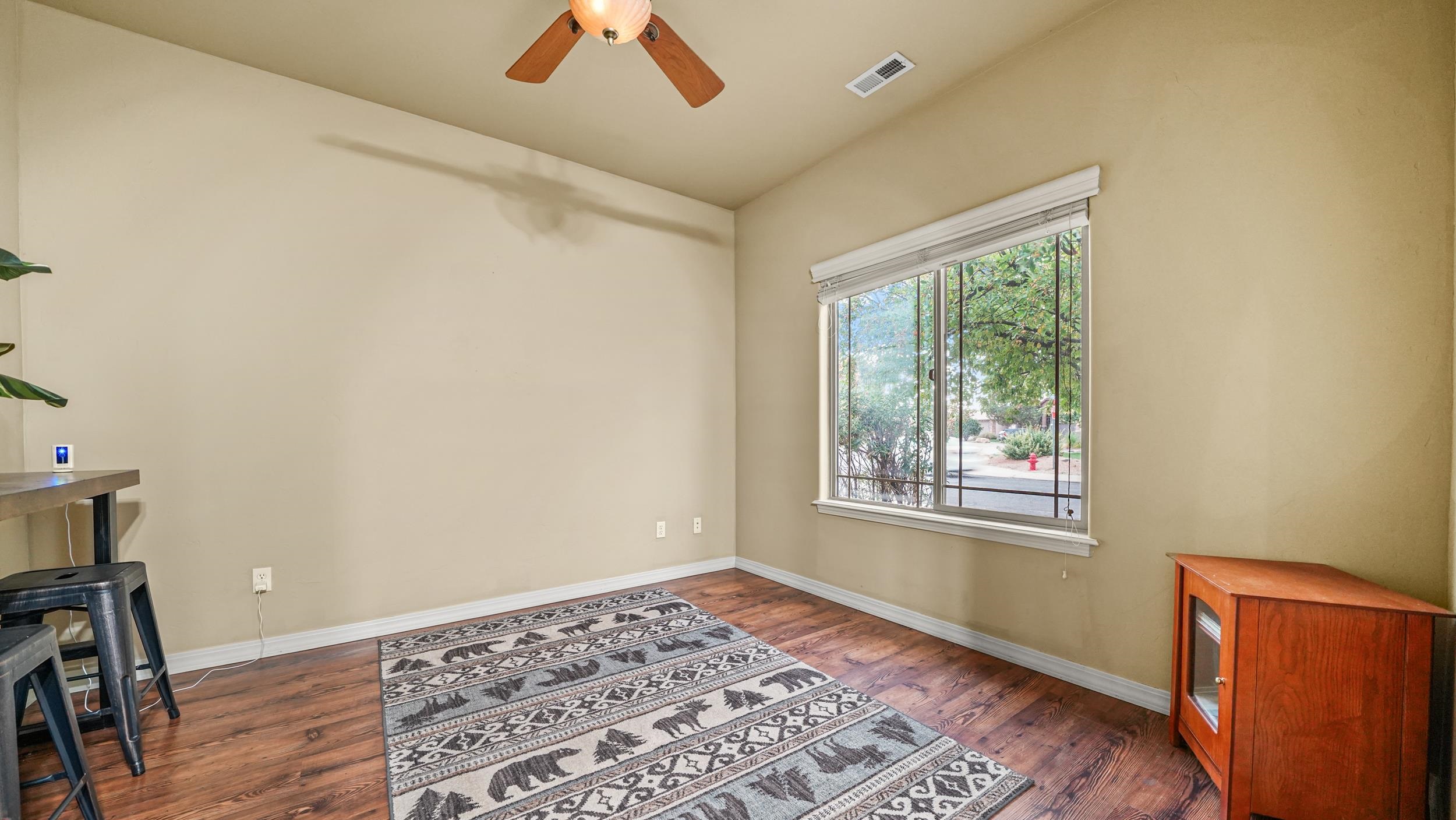 791 Yew Street Fruita, CO 81521 - Photo 21 of 33 a view of an empty room with a window and wooden floor