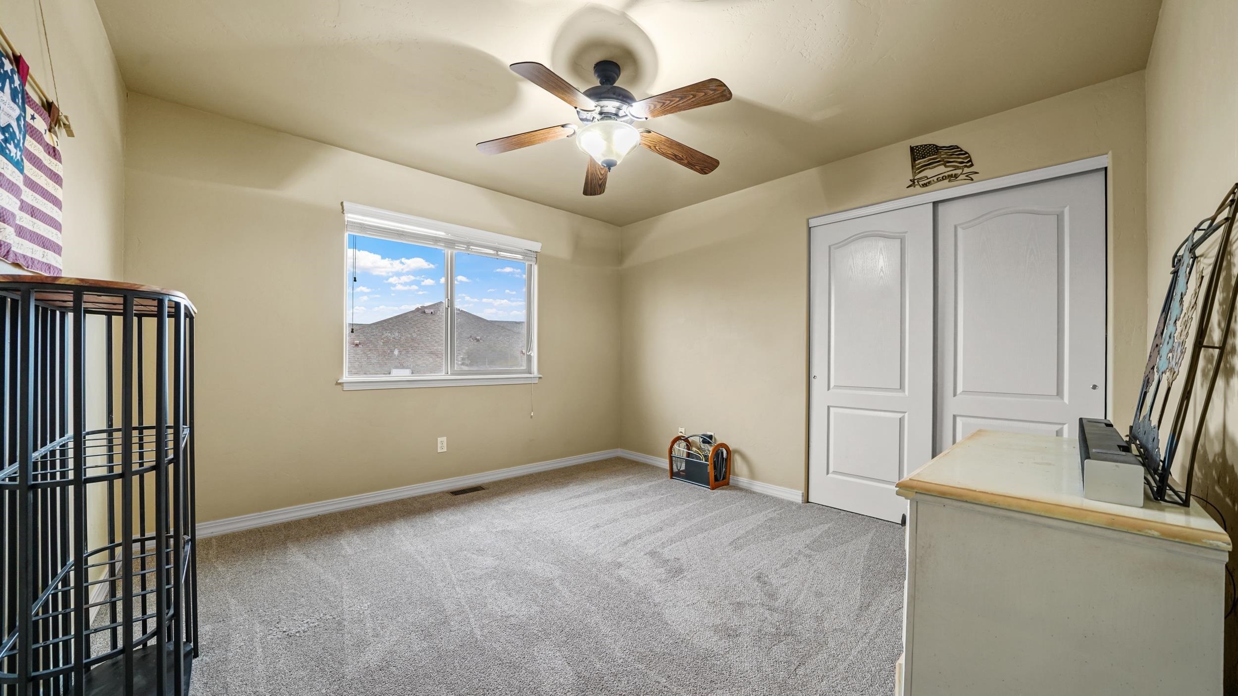 791 Yew Street Fruita, CO 81521 - Photo 23 of 33 an empty room with windows and fan