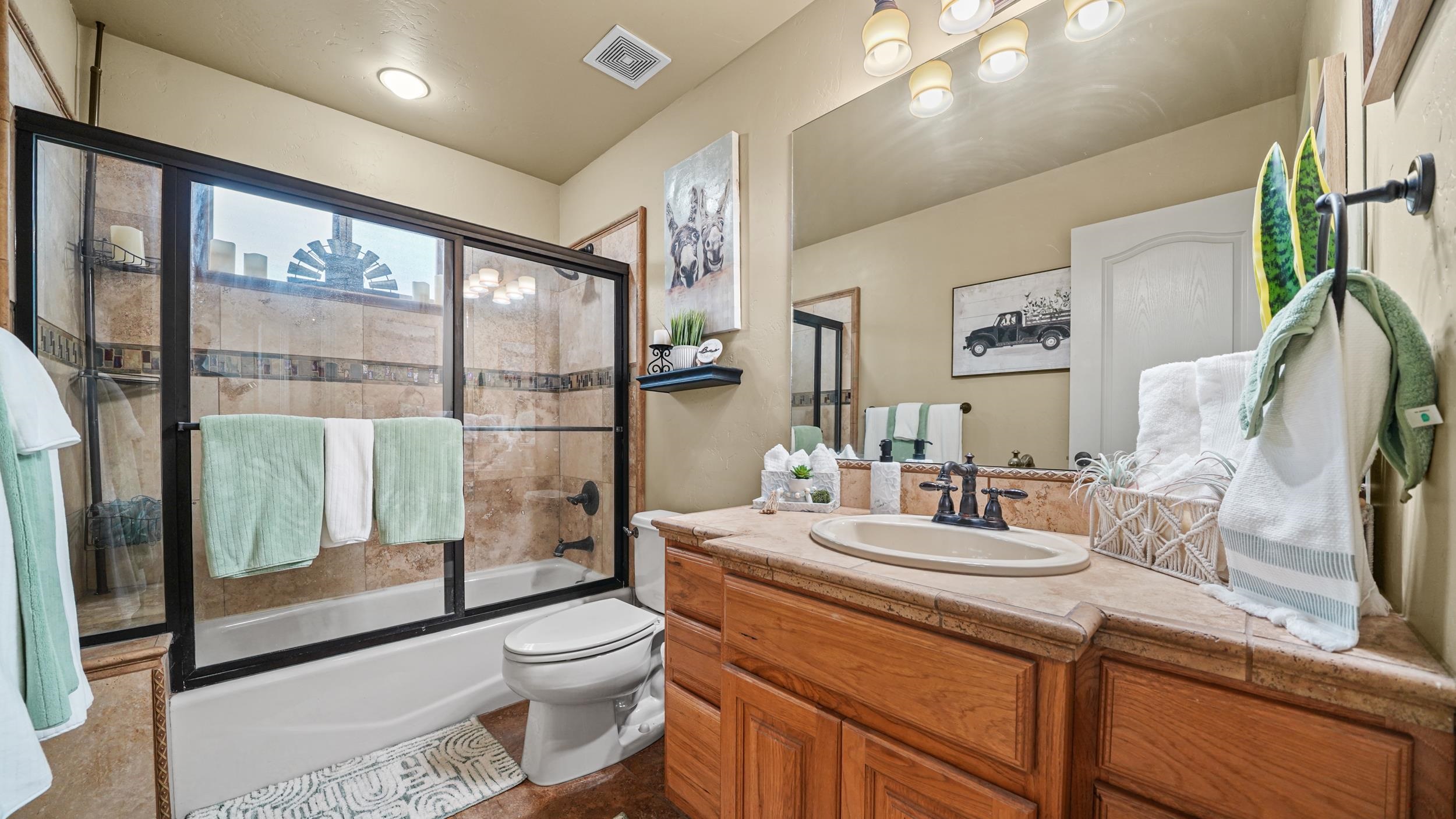 791 Yew Street Fruita, CO 81521 - Photo 25 of 33 a bathroom with a granite countertop sink toilet and shower