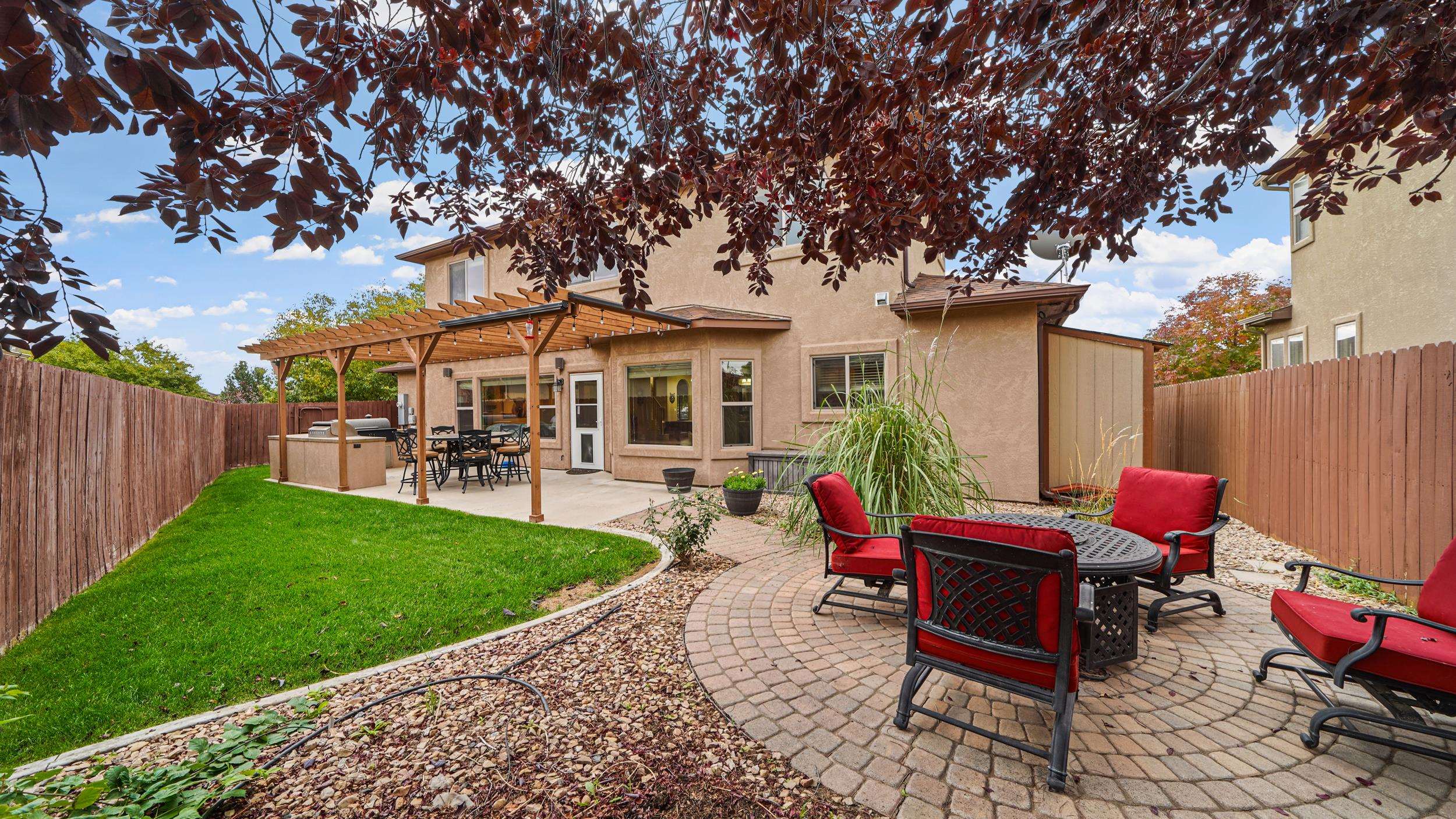 791 Yew Street Fruita, CO 81521 - Photo 28 of 33 a patio with table and chairs under an umbrella