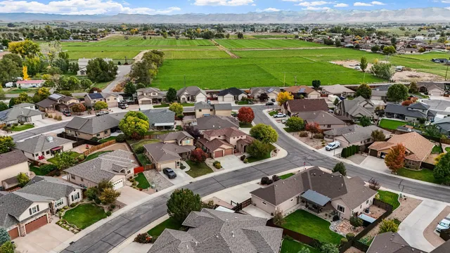 an aerial view of a houses with a swimming pool