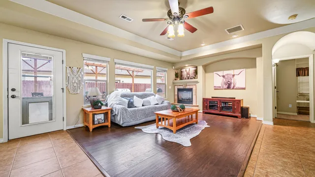 a living room with furniture and wooden floor