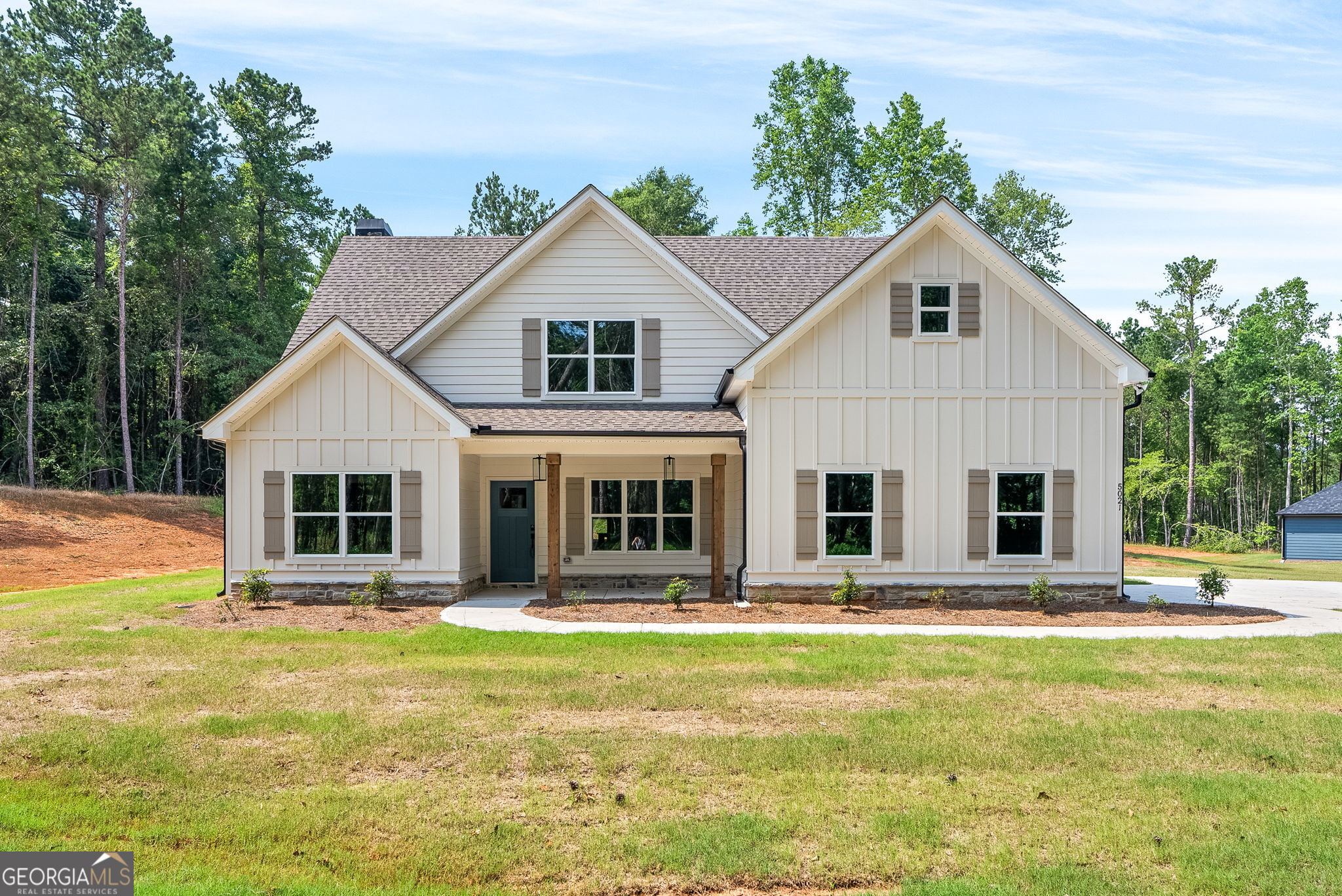 a front view of a house with a yard table and chairs