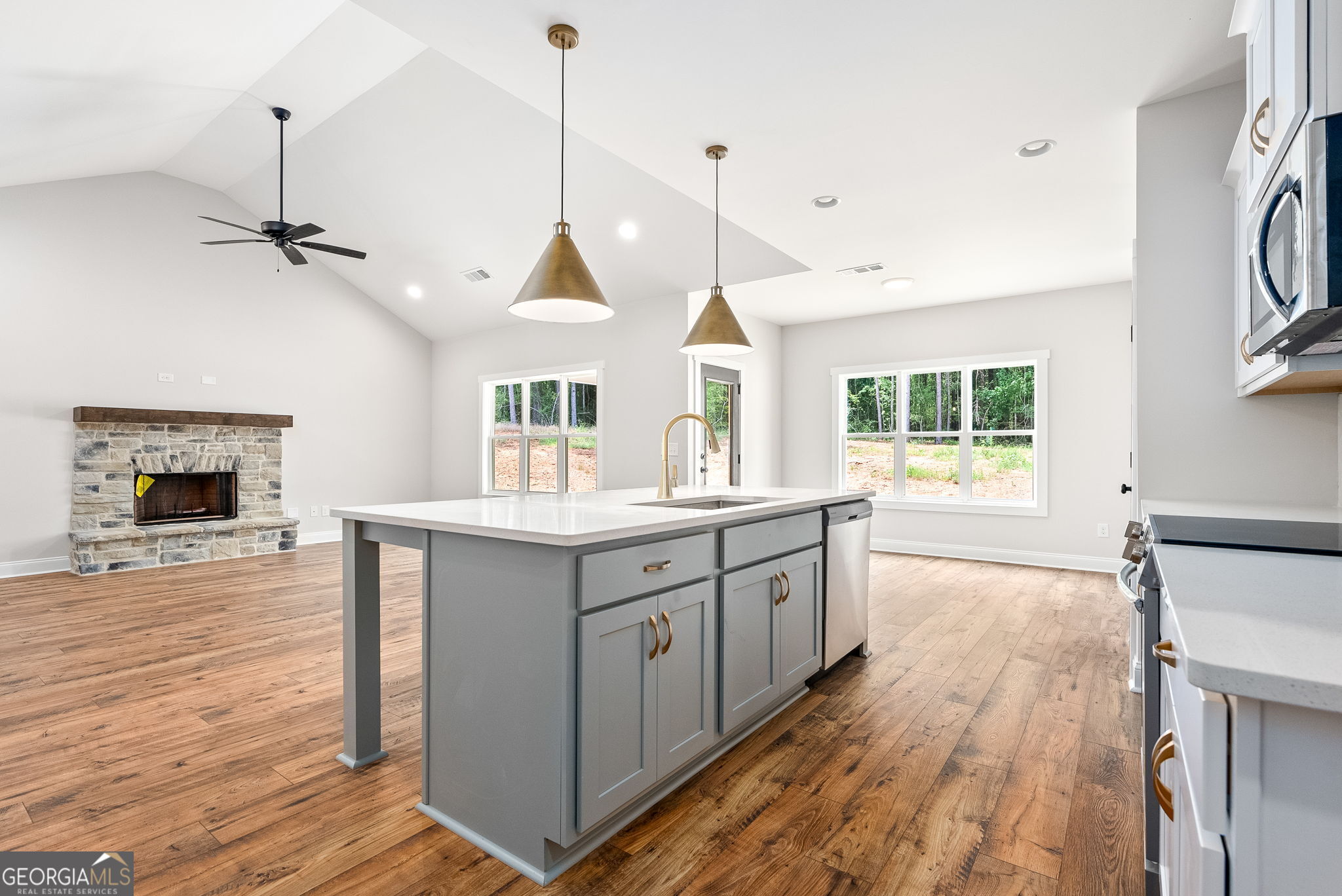 5021 Hammett Road Hogansville, GA 30230 - Photo 12 of 33 a kitchen with stainless steel appliances granite countertop a sink a stove and a wooden floor