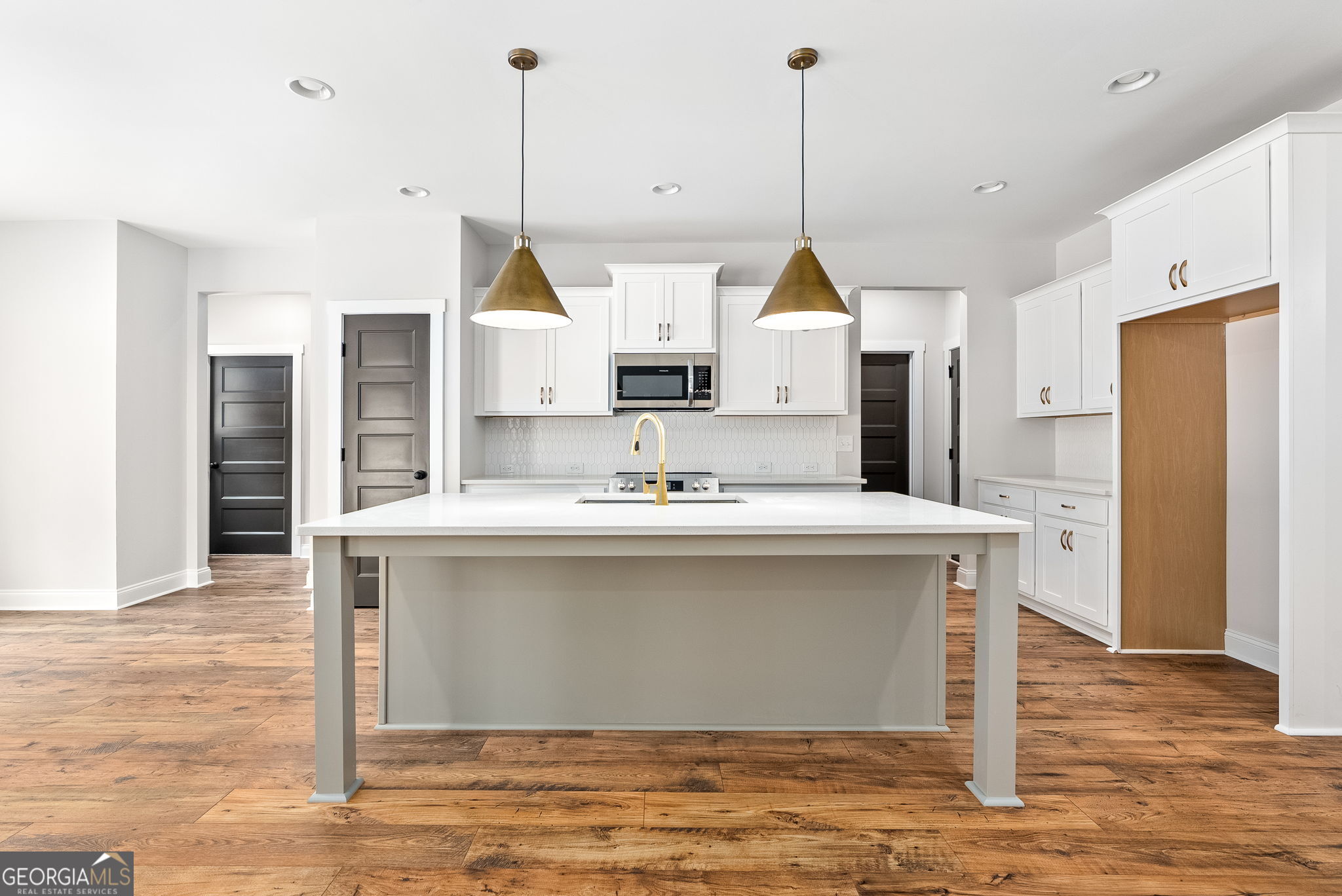 5021 Hammett Road Hogansville, GA 30230 - Photo 9 of 33 a kitchen with kitchen island a sink a counter top space stainless steel appliances and cabinets