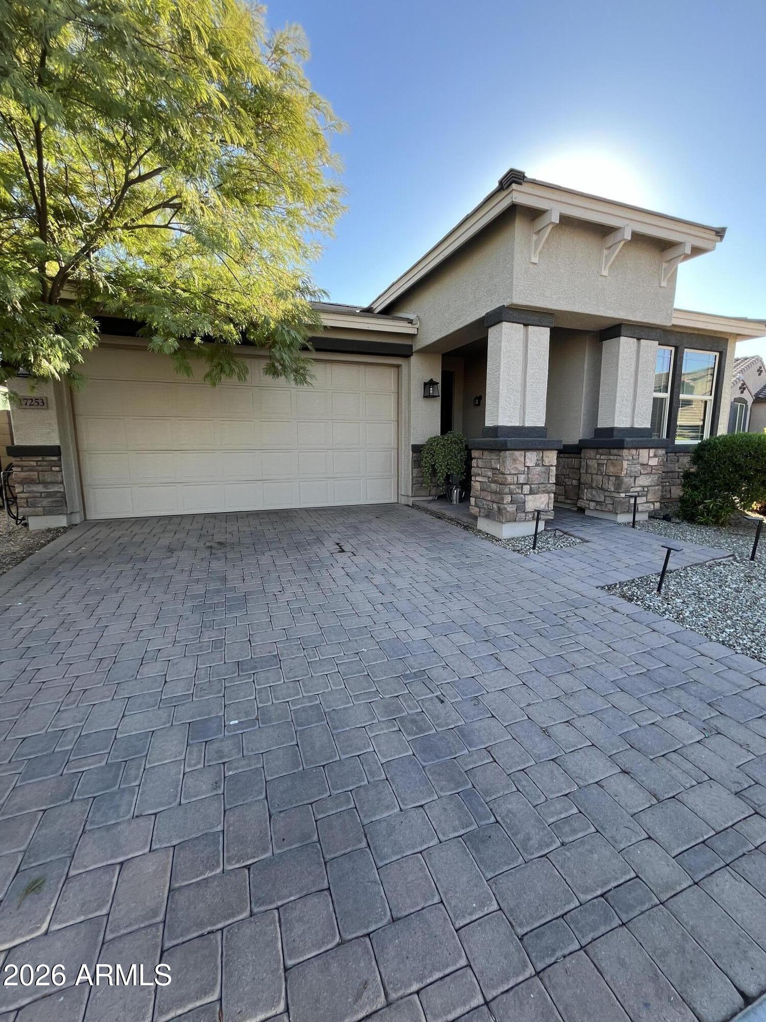 a front view of a house with a yard and garage