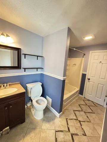 a bathroom with a toilet mirror and vanity